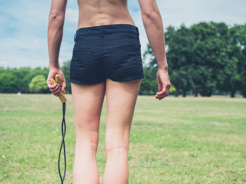 Rear view of woman with jump rope
