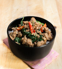Close up Rice topped with stir fried minced pork and basil