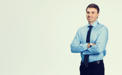 cheerful businessman in blue confident business wear, with copys