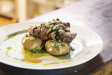 grilled beef steak with garlic sauce and potato