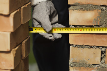Measuring the wall during construction