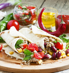 Traditional Mexican burritos with meat and beans, selective focu