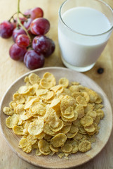 sugar-coated corn flakes with milk and grape background