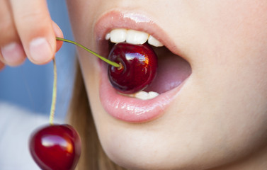 Cherries  in teeth, close up
