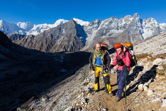 Couple happy backpackers standing  Himalaya snow trail.