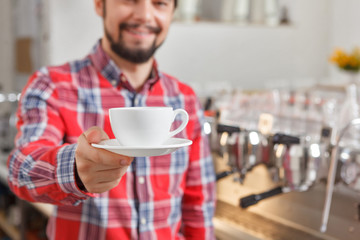 Fototapeta na wymiar Close up of man giving cup with coffee