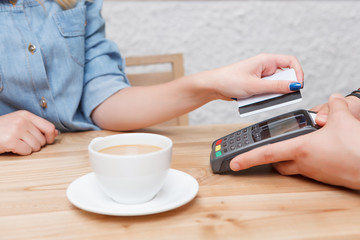  Close up of client paying with payment terminal