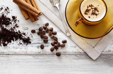 Coffee cup and beans on a wooden table