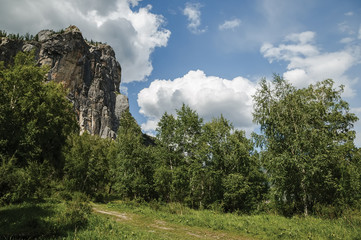 rock on a background of blue sky and clouds