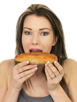 Attractive Young Woman Eating A Baked Cornish Pasty