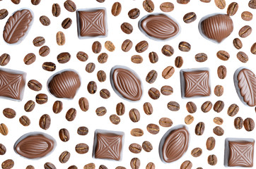 Assorted chocolate candy on the background of coffee beans isola
