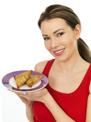 Attractive Young Woman Holding a Plate of Indian Style Samosa Vegetarian Snacks