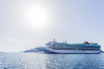 Fototapeta na wymiar Big cruise liner goes from port