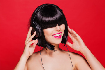 Woman listening to music on headphones enjoying a singing