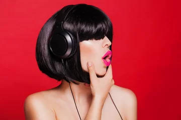 Meubelstickers Woman listening to music on headphones enjoying a singing © milazvereva