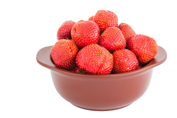 fresh strawberries in clay bowl isolated over white