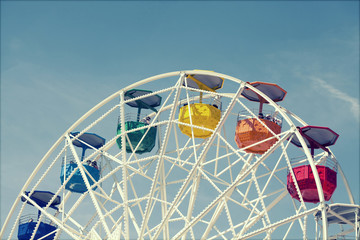 Ferris wheel over blue sky