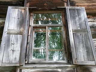 Window with shutters of old wooden house