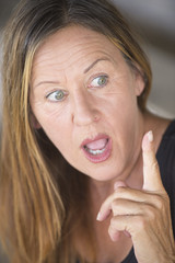 Surprised woman with idea finger pointing