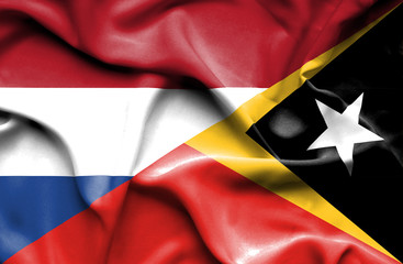 Waving flag of East Timor and Netherlands