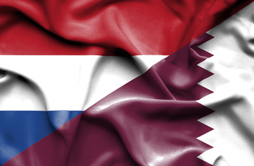 Waving flag of Qatar and Netherlands