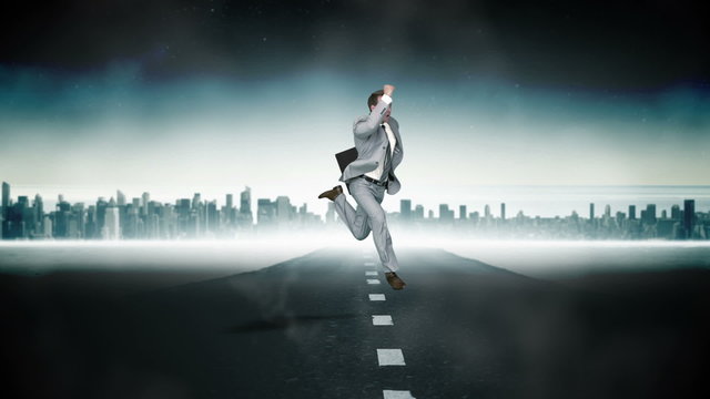 Businessman jumping with city on background