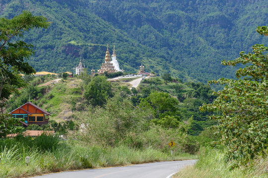  road to 5 white buddha statue and buddhist pagoda on the hill