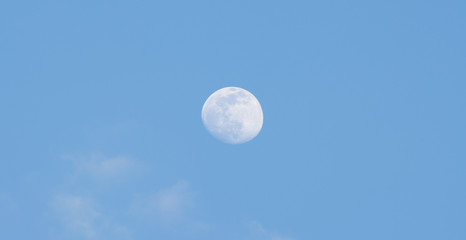 The full moon in the sky during the day.