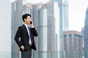 Young businessman talk to mobile phone