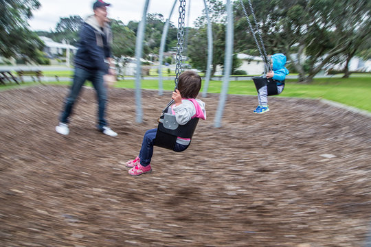 Toddlers on swing
