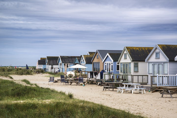Lovely beach huts on sand dunes and beach landscape