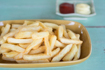 Traditional French fries with ketchup on dish