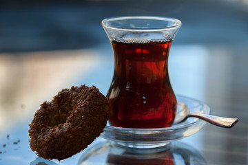 traditional Turkish tea in tulip or thin-waisted glass with mini sesame ring