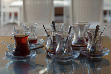 full and empty traditional Turkish tea glasses