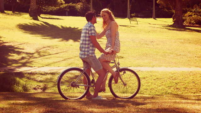 Cute couple on a bike ride in the park