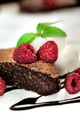 Chocolate brownie with fruit and mint close up