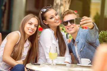 friends  at cafe taking selfie in a cafe