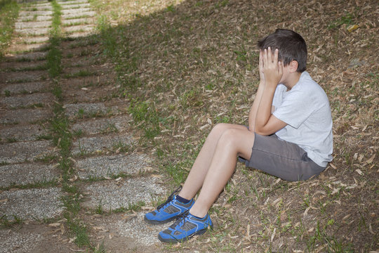 Little boy covering eyes 