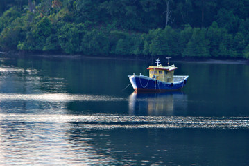 Fototapeta na wymiar Fisherman boat docked by the shore of Mengkabong cove, Tuaran, S