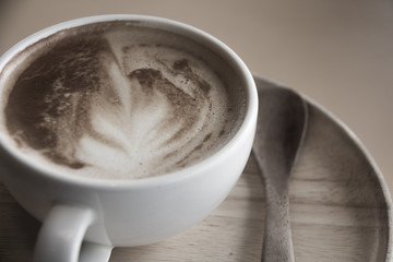 hot latte coffee on the wooden table