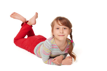 Front view of smiling child girl lying on floor