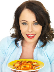 Pretty Attractive Young Woman Holding and Eating a Plate of Ravioli