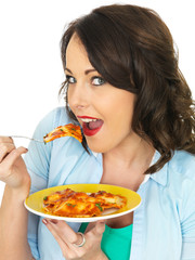 Pretty Attractive Young Woman Holding and Eating a Plate of Ravioli