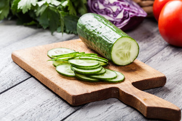 Chopped vegetables: cucumber on cutting board