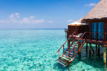 Panorama of tropical island resort with overwater bungalows at night. Maldives. Ari Atoll.