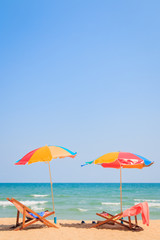 Naklejka premium Beach chair and umbrella on sand beach