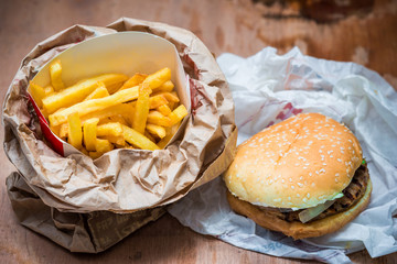 Hamburger with fries on a wooden table