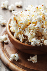 Salt popcorn on the wooden table