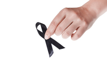 Black ribbon held in a female hand on white background
