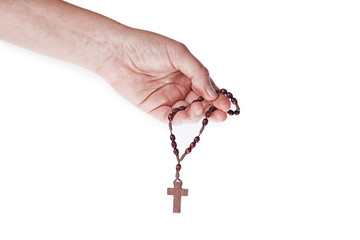 A female hand holding brown wooden rosary on a white background
